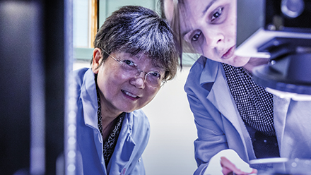 Jane Wang working with student in lab